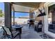 Stylish covered patio featuring an outdoor kitchen and comfortable seating, perfect for outdoor gatherings at 5629 Portage Lake Ct, Las Vegas, NV 89130