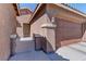 Inviting home exterior with a well-maintained stucco facade, a secure front gate and two-car garage at 5629 Portage Lake Ct, Las Vegas, NV 89130