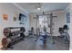 Home gym equipped with weights, weight machines, and rubber flooring at 5629 Portage Lake Ct, Las Vegas, NV 89130
