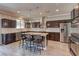 Modern kitchen with stainless steel appliances, granite countertops, and bar stool seating at 5629 Portage Lake Ct, Las Vegas, NV 89130