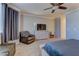 Comfortable sitting area in main bedroom with soft carpeting, a recliner, and natural light at 5629 Portage Lake Ct, Las Vegas, NV 89130