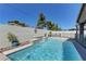 Inviting pool area with decorative features, landscaping and a safety fence, perfect for relaxation at 5629 Portage Lake Ct, Las Vegas, NV 89130