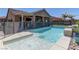 Resort-style backyard with a refreshing pool, covered patio, spa and tropical landscaping for entertaining at 5629 Portage Lake Ct, Las Vegas, NV 89130