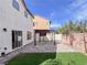 Enjoy this backyard featuring a covered patio and low-maintenance artificial turf at 5664 Dawn Falls St, Las Vegas, NV 89148
