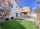 This beautiful backyard has a well maintained lawn and a covered patio at 5664 Dawn Falls St, Las Vegas, NV 89148