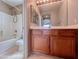 Bathroom with a bathtub and wood cabinets at 5664 Dawn Falls St, Las Vegas, NV 89148