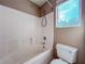Bathroom with white tiled shower and window at 5664 Dawn Falls St, Las Vegas, NV 89148