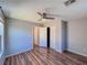 Neutral bedroom with wood-look floors, ceiling fan, and a closet at 5664 Dawn Falls St, Las Vegas, NV 89148