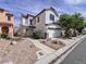 Attractive two-story home with a tiled roof, a two-car garage, and desert landscaping at 5664 Dawn Falls St, Las Vegas, NV 89148