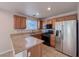 Bright kitchen with stainless steel appliances and light wood cabinets at 5664 Dawn Falls St, Las Vegas, NV 89148