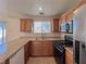 Well-lit kitchen with stainless steel appliances and wood cabinets at 5664 Dawn Falls St, Las Vegas, NV 89148