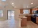 Functional kitchen featuring a breakfast bar, modern appliances, and sliding glass door at 5664 Dawn Falls St, Las Vegas, NV 89148