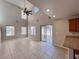 Comfortable living room with tile flooring, large windows, and an open kitchen area at 5664 Dawn Falls St, Las Vegas, NV 89148