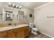 Clean bathroom with stylish vanity, toilet, and decorative mirror at 5855 Valley Dr # 1080, North Las Vegas, NV 89031