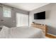 Comfortable bedroom featuring natural light, TV, and neutral tones at 5855 Valley Dr # 1080, North Las Vegas, NV 89031