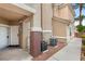 Tan two-story home featuring a covered entryway, concrete pathway, and well-maintained exterior at 5855 Valley Dr # 1080, North Las Vegas, NV 89031