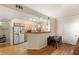 Cozy kitchen with wood cabinetry, breakfast bar, and adjacent dining area at 5855 Valley Dr # 1080, North Las Vegas, NV 89031