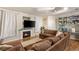 Comfortable living room with built-in shelving, large sectional, fireplace, and hardwood floors at 5855 Valley Dr # 1080, North Las Vegas, NV 89031