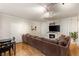 Spacious living room with hardwood floors, fireplace, large sectional couch, and natural light at 5855 Valley Dr # 1080, North Las Vegas, NV 89031