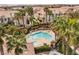 Inviting community pool surrounded by palm trees and lounge chairs at 5855 Valley Dr # 1080, North Las Vegas, NV 89031