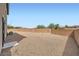 A spacious backyard featuring low-maintenance gravel and a secure block wall at 6153 Sea Cliff Cove St, North Las Vegas, NV 89031