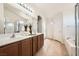 Well-lit bathroom showcasing double sinks, granite counters, and a separate tub and shower at 6153 Sea Cliff Cove St, North Las Vegas, NV 89031
