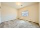 Serene bedroom featuring neutral tones, plush carpeting, and a window offering natural light at 6153 Sea Cliff Cove St, North Las Vegas, NV 89031