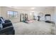 Large carpeted room with exercise equipment, mirrors, and comfortable seating, ideal for a home gym at 6153 Sea Cliff Cove St, North Las Vegas, NV 89031