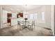Cozy dining area adjacent to the kitchen with natural light, modern chandelier, and seating for four at 6153 Sea Cliff Cove St, North Las Vegas, NV 89031