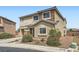 Charming two-story home featuring a stone facade, desert landscaping, and a covered entryway, perfect for curb appeal at 6153 Sea Cliff Cove St, North Las Vegas, NV 89031