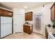 Functional kitchen showcasing ample cabinetry, granite countertops, and a door leading to the backyard area at 6153 Sea Cliff Cove St, North Las Vegas, NV 89031