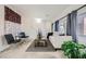 Bright living room with neutral color palette, showcasing large windows with curtains and stylish decor at 6153 Sea Cliff Cove St, North Las Vegas, NV 89031