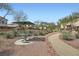 Community park with seating and walking paths surrounded by desert landscaping at 6153 Sea Cliff Cove St, North Las Vegas, NV 89031