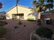 Private backyard with desert landscaping and patio area at 6475 Benbrook Springs Dr, Las Vegas, NV 89131