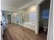 Bathroom features a walk in shower and separate tub at 6475 Benbrook Springs Dr, Las Vegas, NV 89131