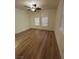 Bright bedroom features two arched windows with blinds and hardwood flooring at 6475 Benbrook Springs Dr, Las Vegas, NV 89131