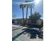 Charming single-story home with desert landscaping and mature palm trees at 6475 Benbrook Springs Dr, Las Vegas, NV 89131