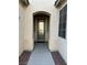 Front entrance featuring a decorative glass door, stucco pillars and rock landscaping at 6475 Benbrook Springs Dr, Las Vegas, NV 89131