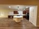 Open kitchen featuring a center island, stainless steel appliances, and wood-look floors at 6475 Benbrook Springs Dr, Las Vegas, NV 89131