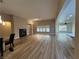 Spacious open-plan living room with a fireplace and wood look flooring at 6475 Benbrook Springs Dr, Las Vegas, NV 89131