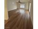 Bright living room with a ceiling fan and wood look flooring at 6475 Benbrook Springs Dr, Las Vegas, NV 89131
