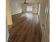 Bright living room with a ceiling fan and wood look flooring at 6475 Benbrook Springs Dr, Las Vegas, NV 89131