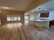 Living room showcasing a kitchen island, abundant natural light, and vinyl flooring at 6475 Benbrook Springs Dr, Las Vegas, NV 89131