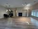 Spacious living room with vinyl flooring, a fireplace, and plenty of windows at 6475 Benbrook Springs Dr, Las Vegas, NV 89131