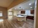 Open-concept living room and kitchen with wood-look floors and plenty of natural light at 6475 Benbrook Springs Dr, Las Vegas, NV 89131