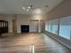 Open-concept living area featuring fireplace, vinyl flooring, and recessed lighting at 6475 Benbrook Springs Dr, Las Vegas, NV 89131
