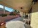 Covered patio featuring a ceiling fan and access to the backyard with desert landscaping at 6475 Benbrook Springs Dr, Las Vegas, NV 89131
