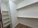 This walk-in closet boasts plenty of storage with sturdy rods and shelving units at 6475 Benbrook Springs Dr, Las Vegas, NV 89131