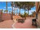 Well-maintained backyard with outdoor BBQ, mature trees, and desert landscaping at 6654 Coronado Crest Ave, Las Vegas, NV 89139