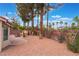 Spacious backyard with desert landscaping, patio area, and mature trees at 6654 Coronado Crest Ave, Las Vegas, NV 89139